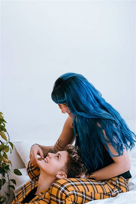 lesbian couple dressed in a yellow outfit are comfortable in their bright white room del