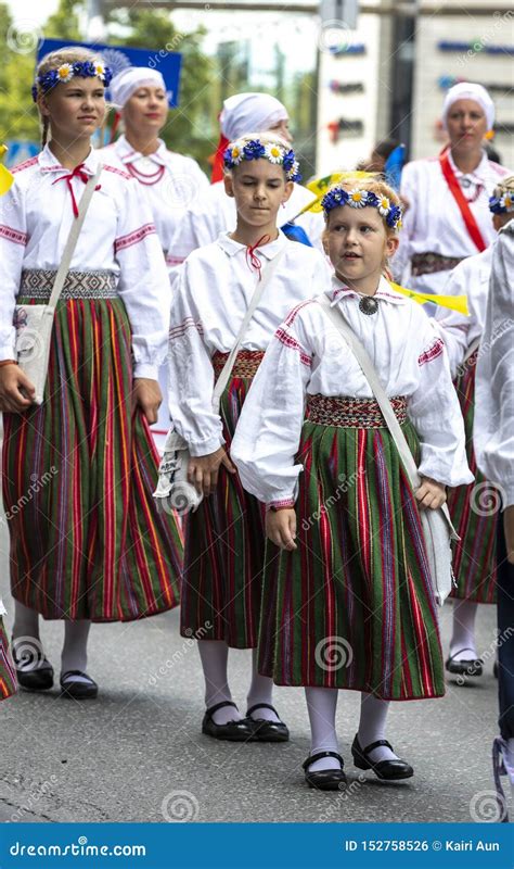 Estonian People In Traditional Clothing Walking The Streets Of Tallinn