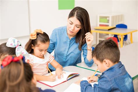 Preschool Teacher Helping Her Pupils Stock Image Image Of Latin