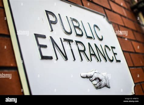 Public Entrance Sign Against A Brick Wall Stock Photo Alamy