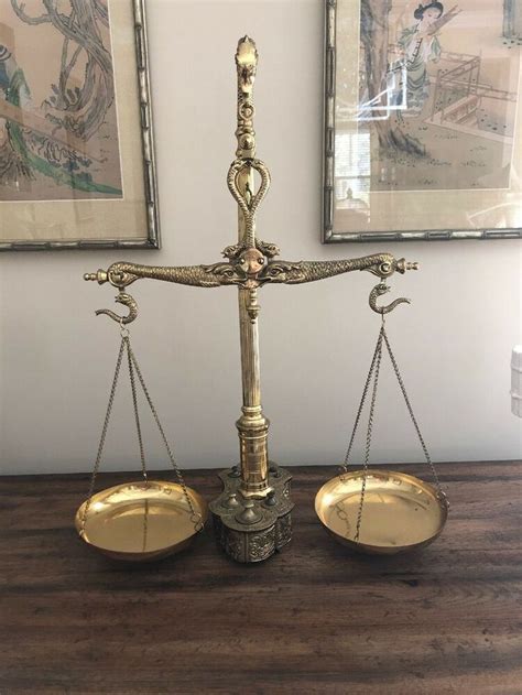 An Old Scale With Two Gold Scales On It