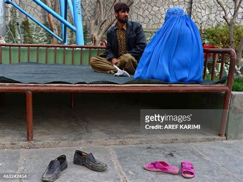 An Afghan Couple Share A Moment As They Sit At A Park In Herat On