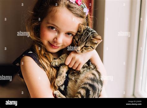 Portrait Of Little Girl Holding Tabby Kitten Stock Photo Alamy