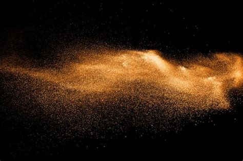 Premium Photo Orange Dust Particles Explosion On Black Background