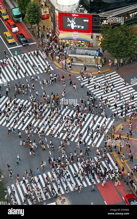 People Crossing The Pedestrian Crossing At The Intersection In Shibuya