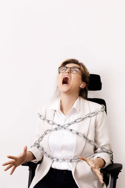 Premium Photo Angry Business Woman Tied Up To The Office Chair With A Chains Concept Of Debts