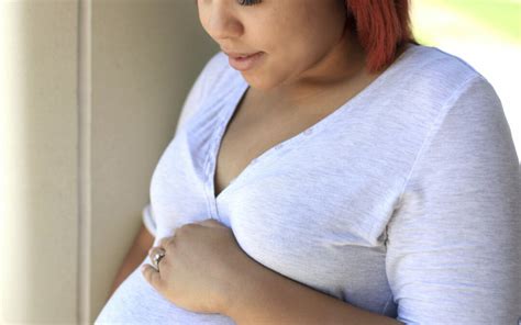 Pregnant Woman Holds Her Tummy And Looks At It Worklife Law