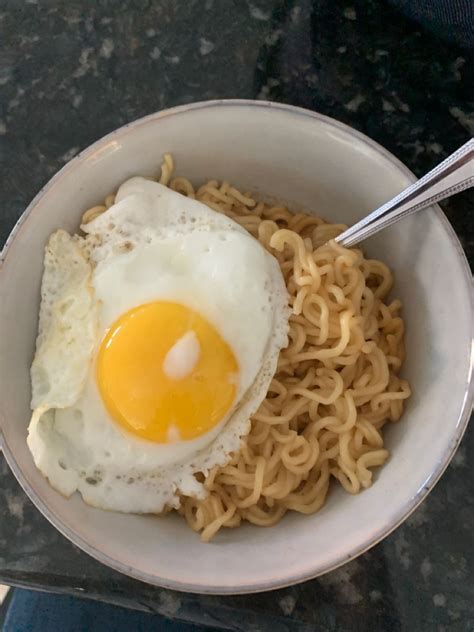 An Egg On Top Of Noodles In A Bowl
