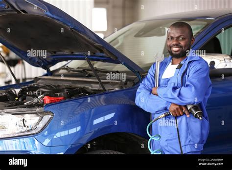 African American Mechanic Working In Car Service Center Stock Photo Alamy