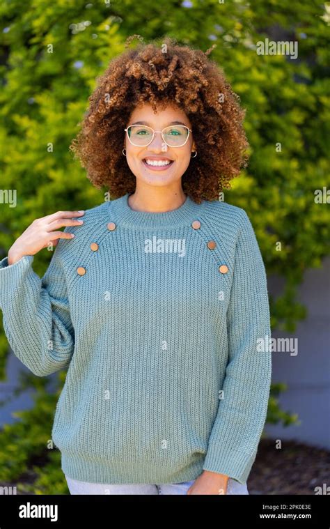 Portrait Of Biracial Beautiful Young Woman With Afro Hair Smiling And