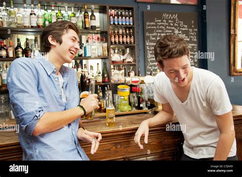 Smiling Men Drinking Beers In Bar Stock Photo Alamy