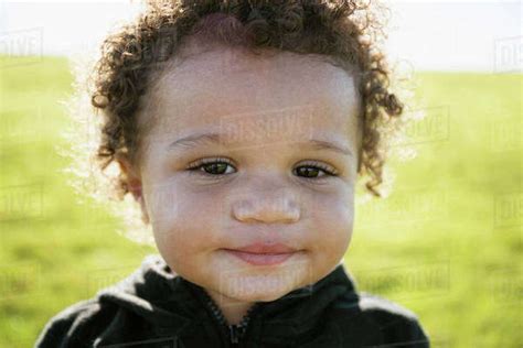 Close Up Of Mixed Race Baby Boy With Curly Hair Stock Photo Dissolve