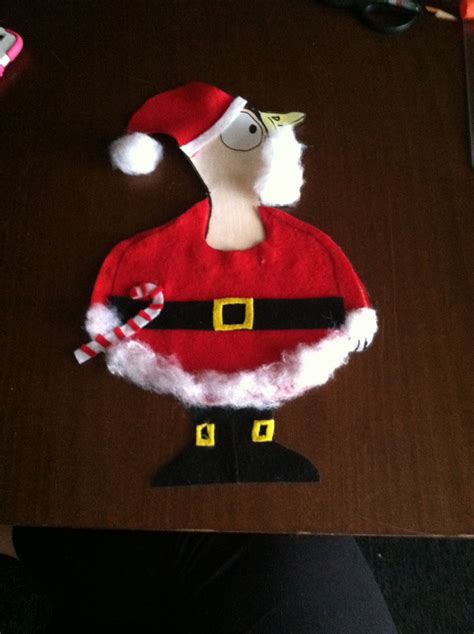 A Santa Clause Hat On Top Of A Wooden Table