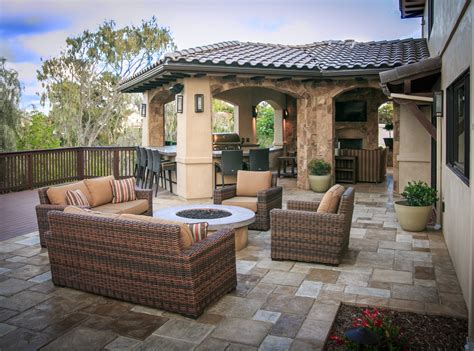 I have a small poured concrete patio, and that i'd like to cover with brick pavers. Example-of-a-mid-sized-tuscan-backyard-concrete-paver ...