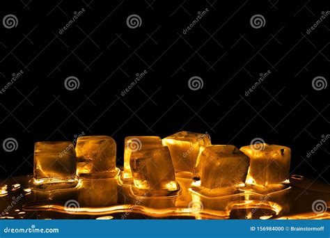 Golden Ice Cubes On Black Background Isolated Closeup Transparent