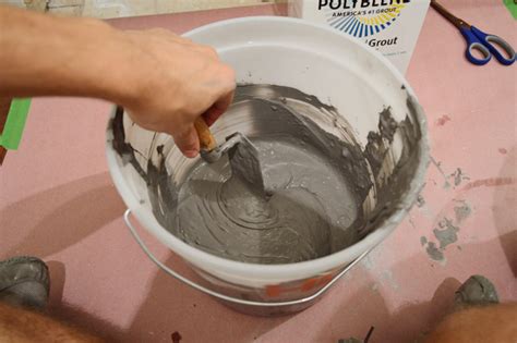 Rolling the bucket occasionally while you're mixing your grout helps to get all of the powder mixed in. Laying Porcelain Tile In The Laundry Room | Young House Love