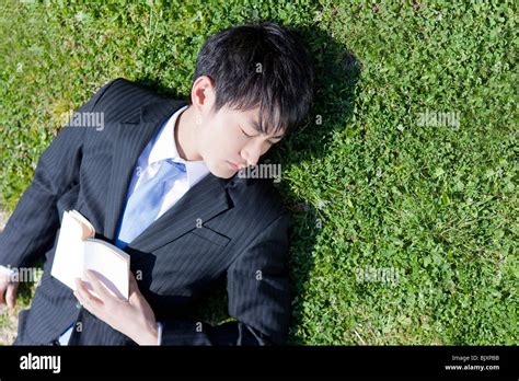 Young Businessman Sleeping On Grass Stock Photo Alamy
