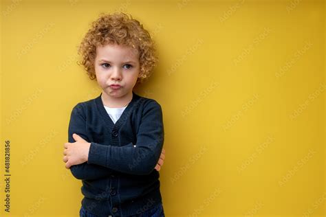 Resentful Sad Child Boy Stand With Arms Folded Posing Isolated On
