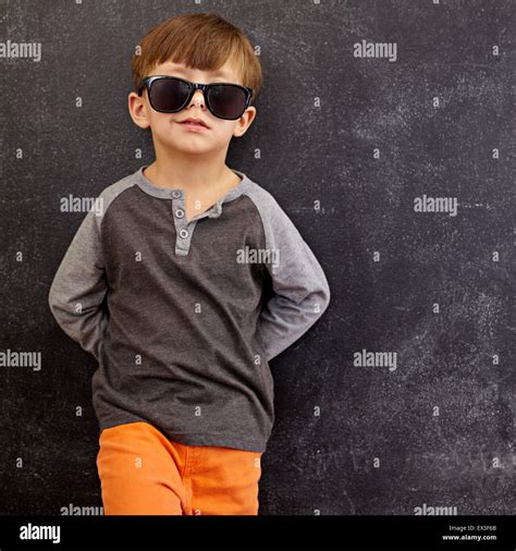 Portrait Of Smart Little Boy Wearing Sunglasses Smirking Cool Kid In