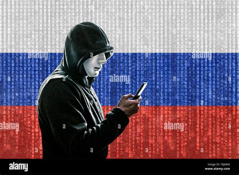 Russian Hooded Hacker With Mask Holding Smartphone Stock Photo Alamy