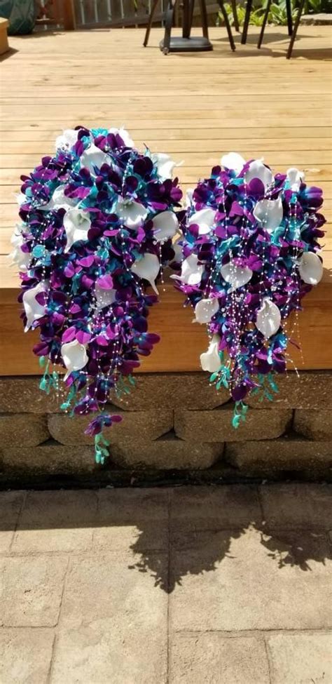 Check out these designs for some major something blue give your 'maids their moment in the spotlight with blue bouquets. Galaxy orchid cascading bridal bouquet, purple blue ...