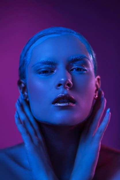 Premium Photo Sexy Woman With Creative Make Up Poses In Blue Lights