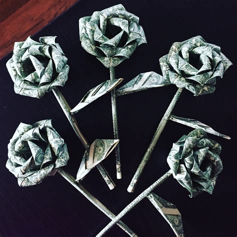 An intricate fold that features a curved, folded rose appearance, this pocket square look is a romantic complement to important occasions: Money roses money flower origami money rose dollar bill ...