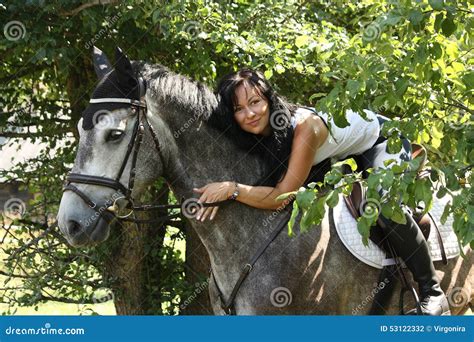 Portrait Of Beautiful Woman And Gray Horse In Garden Stock Photo