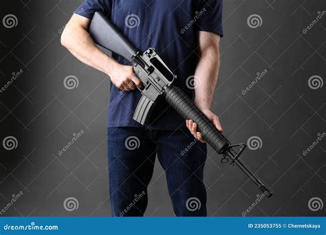 Assault Gun Man Holding Rifle On Dark Background Closeup Stock Image