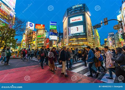 Crowds Of People Walking Across At Shibuya Famous Crossing Street At