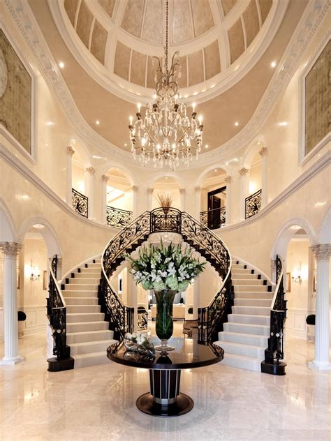 If you're set on achieving the look of a grand entrance, try to work in a curved design that will really showcase the railings and any other unique features. Photos | White staircase, Double staircase, Mansions