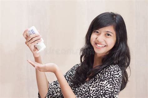 beautiful asian girl using lotion for caring her skin stock image image of enjoy hold 30008559