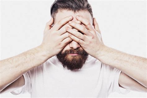 Young Bearded Man Closing His Eyes Over White Background Stock Photo