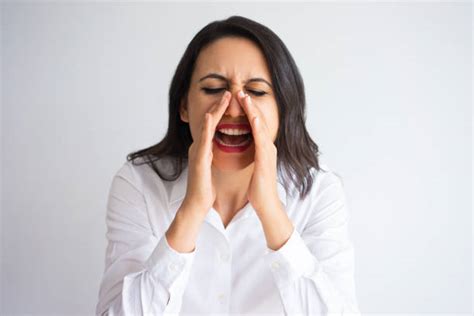 50 A Woman Cupping Her Hand To Her Mouth Shouting Stock Photos