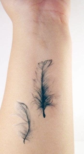 Delicate Feathers Tattoo On Forearm Fairyland Tattoos Wrist Tattoos