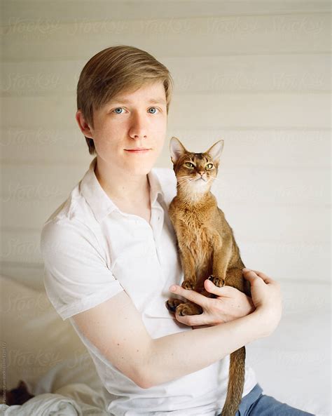 man holding a cat by stocksy contributor duet postscriptum stocksy