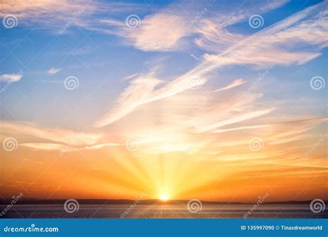 Sunrise With Sun Sun Rays Blue Sky Clouds And Sea Stock Photo