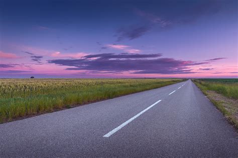 Driving On An Open Asphalt Road At Beautiful Sunset Stock Photo