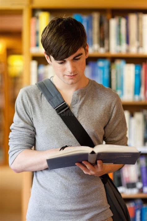 Portrait Of A Handsome Student Reading A Book Stock Photo Image Of
