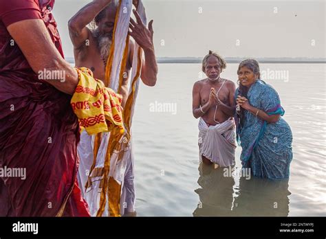 pilgrims praying and bathing in the ghats of ganges river varanasi uttar pradesh india stock