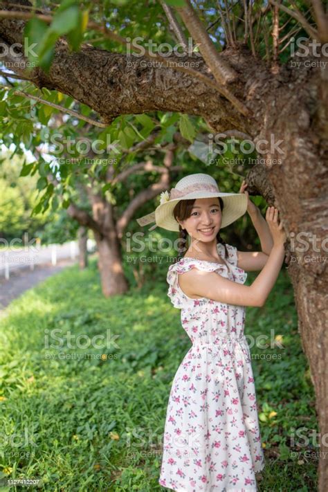 Portrait Of Teenage Girl Standing Near Tree Stock Photo Download