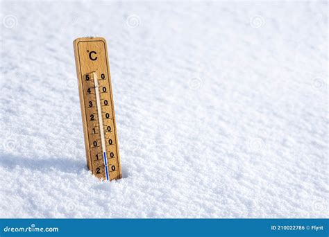 Thermometer In The Snow Background Concept For Winter And Freezing