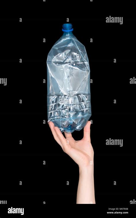 Female Hand Holding Empty Crushed Plastic Bottle Isolated On Black Background Recyclable Waste