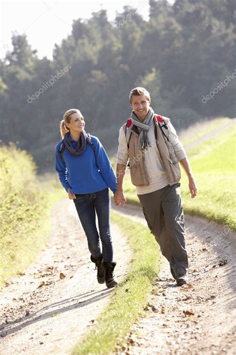 Young Couple Walking In Park — Stock Photo © Monkeybusiness 5190378