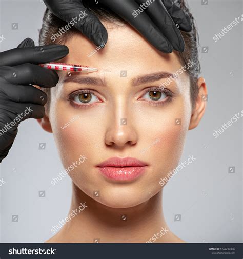 Beautiful Young Woman Getting Botox Cosmetic Injection In Her Face
