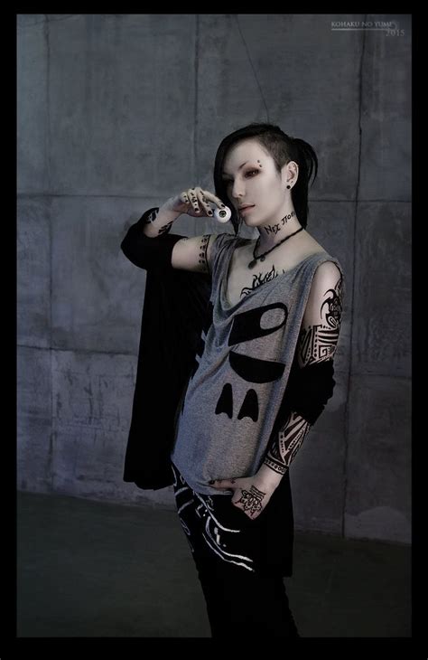A Woman With Tattoos On Her Body Holding A Cell Phone And Posing For