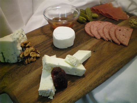 Cheese And Charcuterie Served W Baguette And Seasonal Garnish At The Plaza