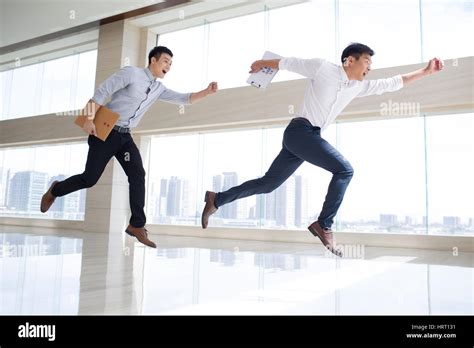 Young Businessmen Running In Office Building Stock Photo Royalty Free