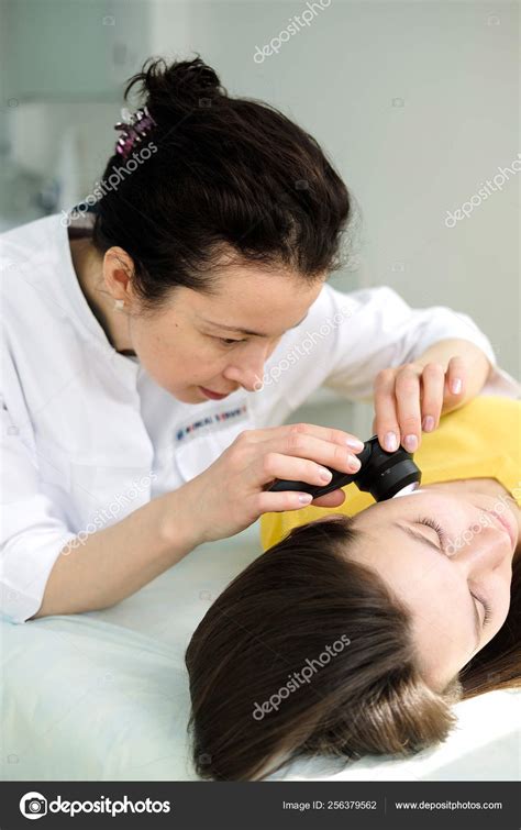 Female Dermatologist Using Professional Dermatoscope While Doing Skin