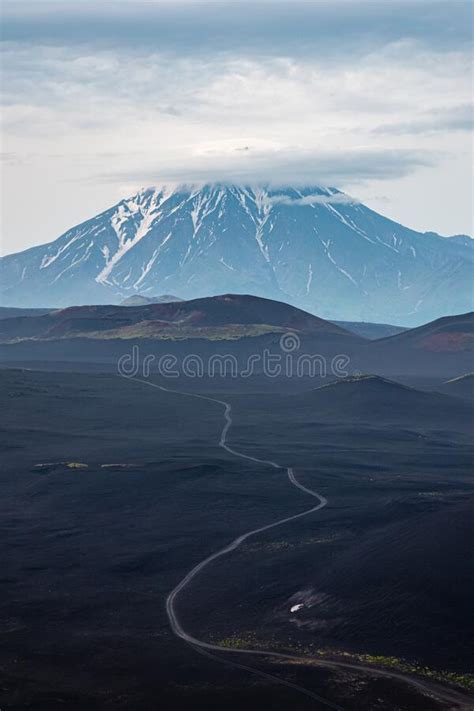 Road To Volcano Snowy Mountain Through Dark Lava Covered Ground And